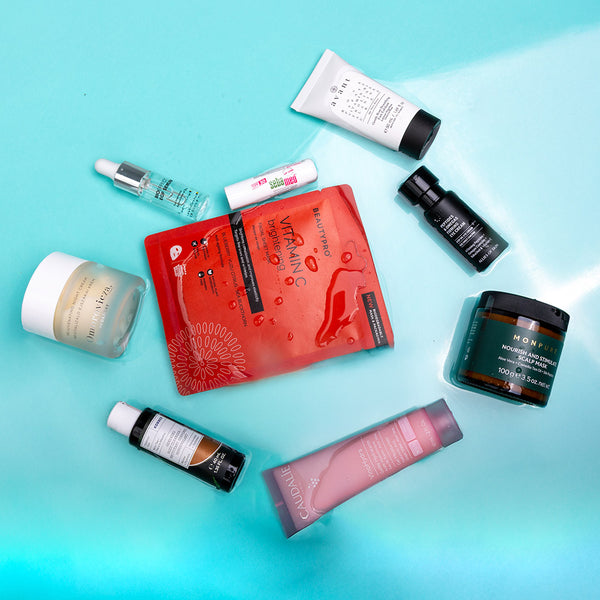 Collection of skincare products on a gradient blue background