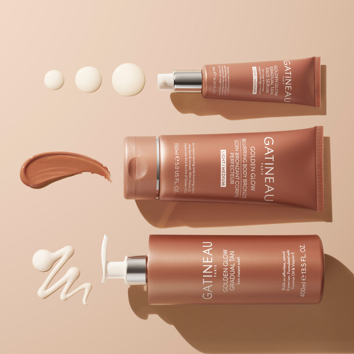 Three tubes of Gatineau Golden Glow Gradual Tan on a beige background
