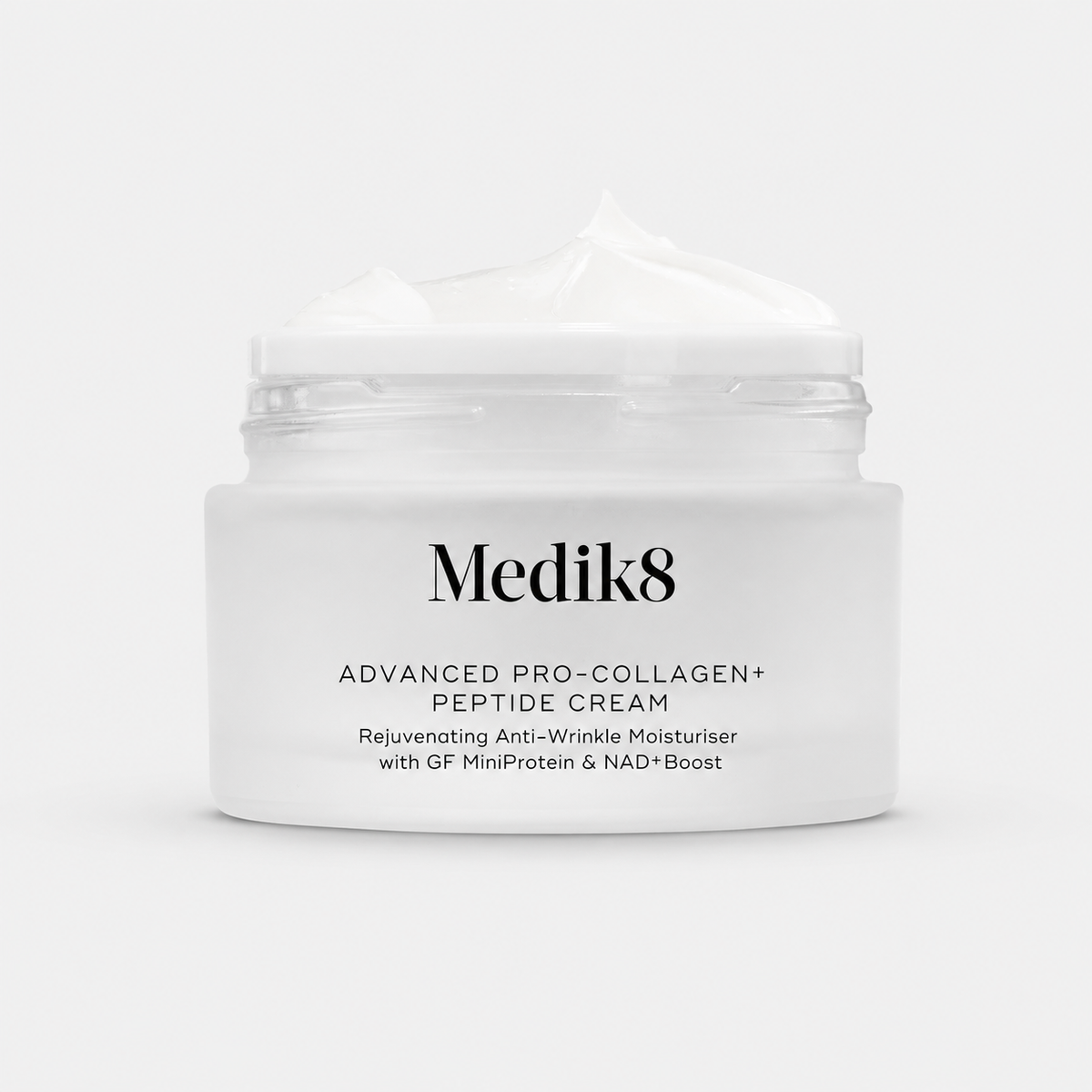A white cosmetic jar of Medik8 Advanced Pro-Collagen+ Peptide Cream with a dollop of cream on top, set against a clean white background.