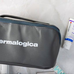Dermalogica cosmetic bag with a tube of sunscreen on a white background