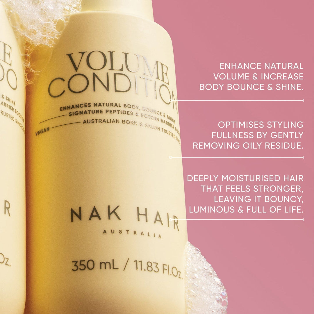 NAK Hair Volume Conditioner bottle with product details on a pink background