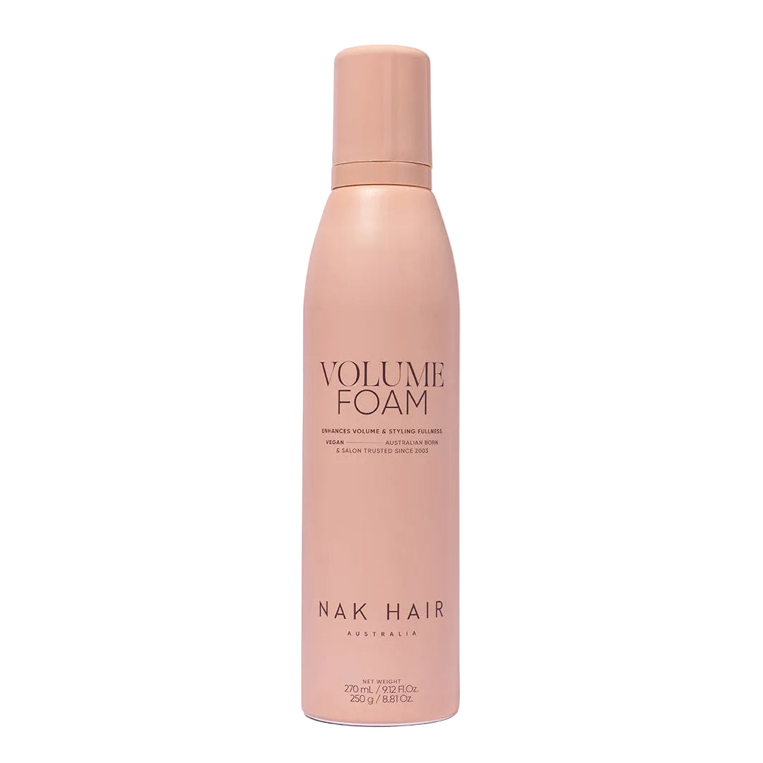 Pink bottle of NAK Hair Volume Foam on a white background