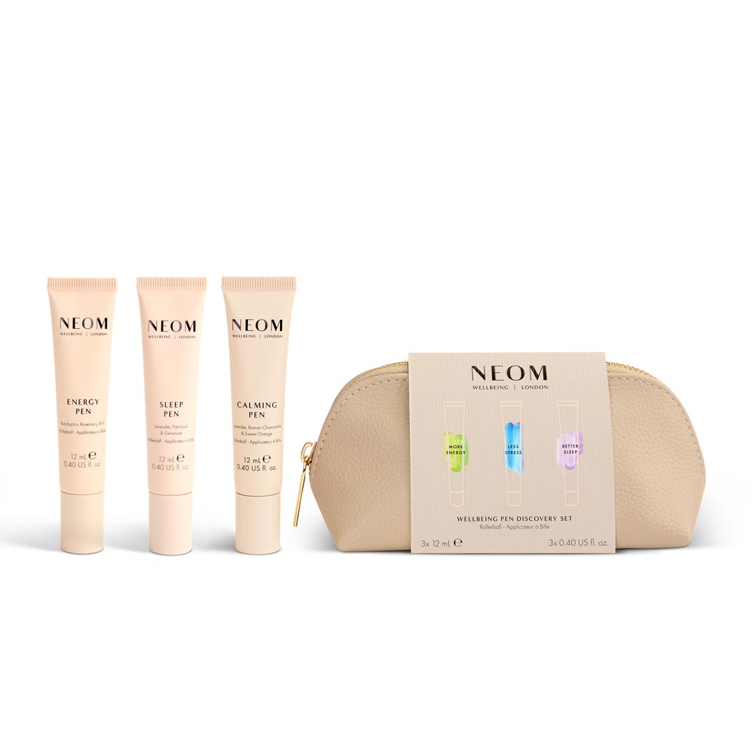 Neom skincare products including tubes and a pouch on a white background