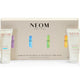 NEOM Moments of Wellbeing in the Palm of Your Hand gift set, featuring a beige presentation box with four small white hand cream tubes arranged in front on a white background.