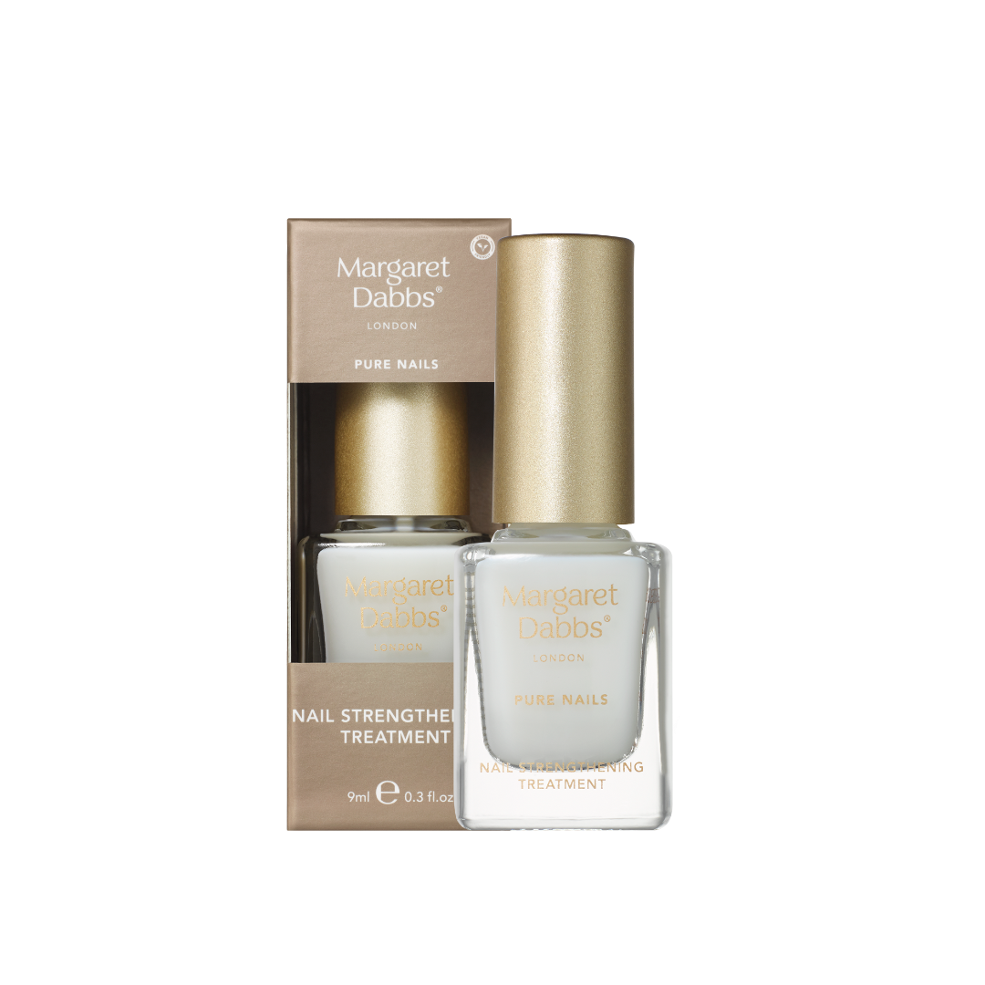A bottle of Margaret Dabbs London Pure Nails nail strengthening treatment with a metallic gold cap, shown next to its matching gold and white cardboard packaging box on a plain white background.