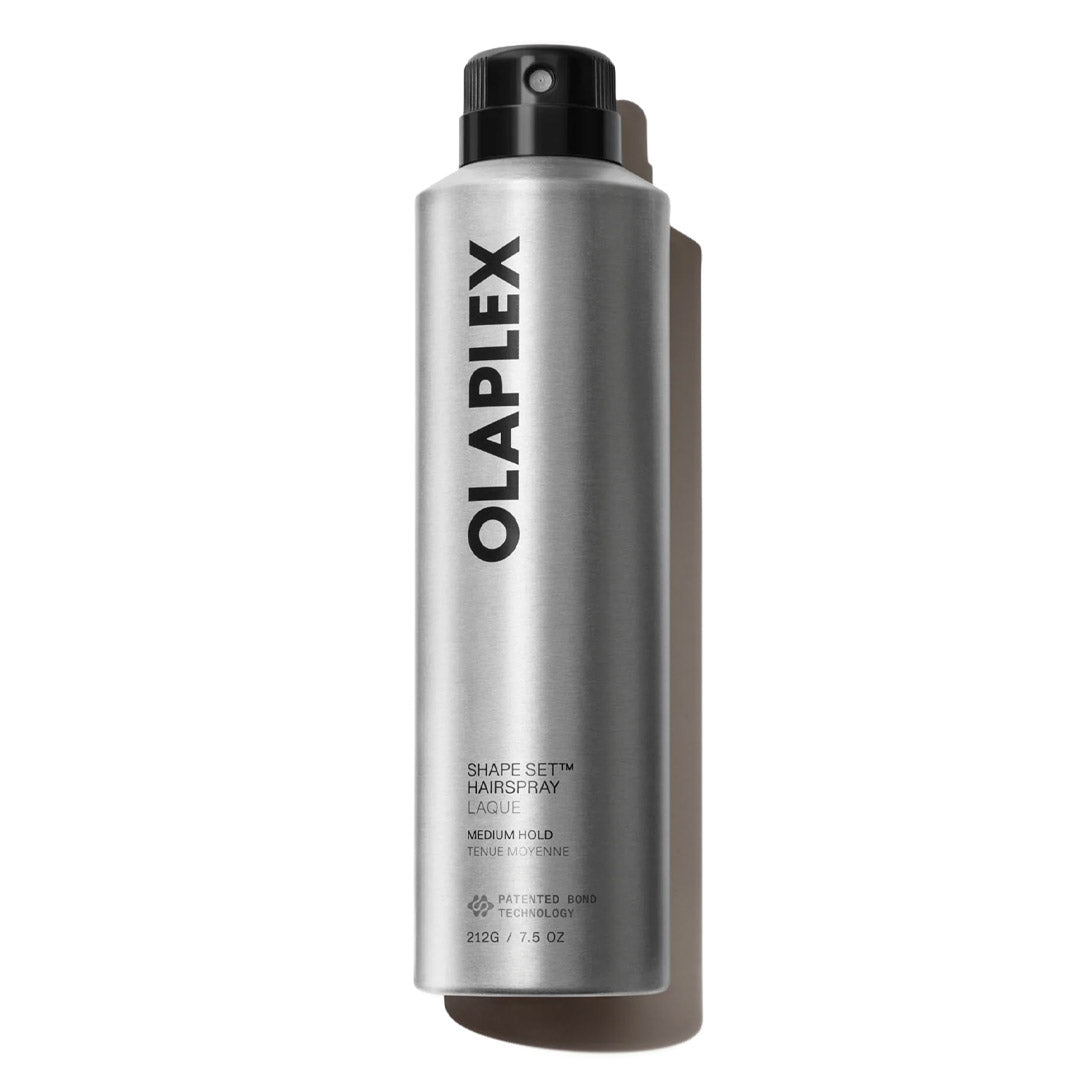 A silver aerosol can of Olaplex Shape Set Hair Spray with a black cap, shown on a clean white background with a soft shadow.