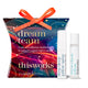 Thisworks Dream Team gift set featuring a colorful gift box with an orange ribbon, alongside two white spray bottles labeled deep sleep pillow spray and stress check roll-on.