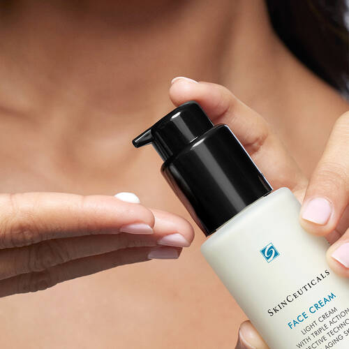 a bottle of SkinCeuticals Face Cream being applied to a hand