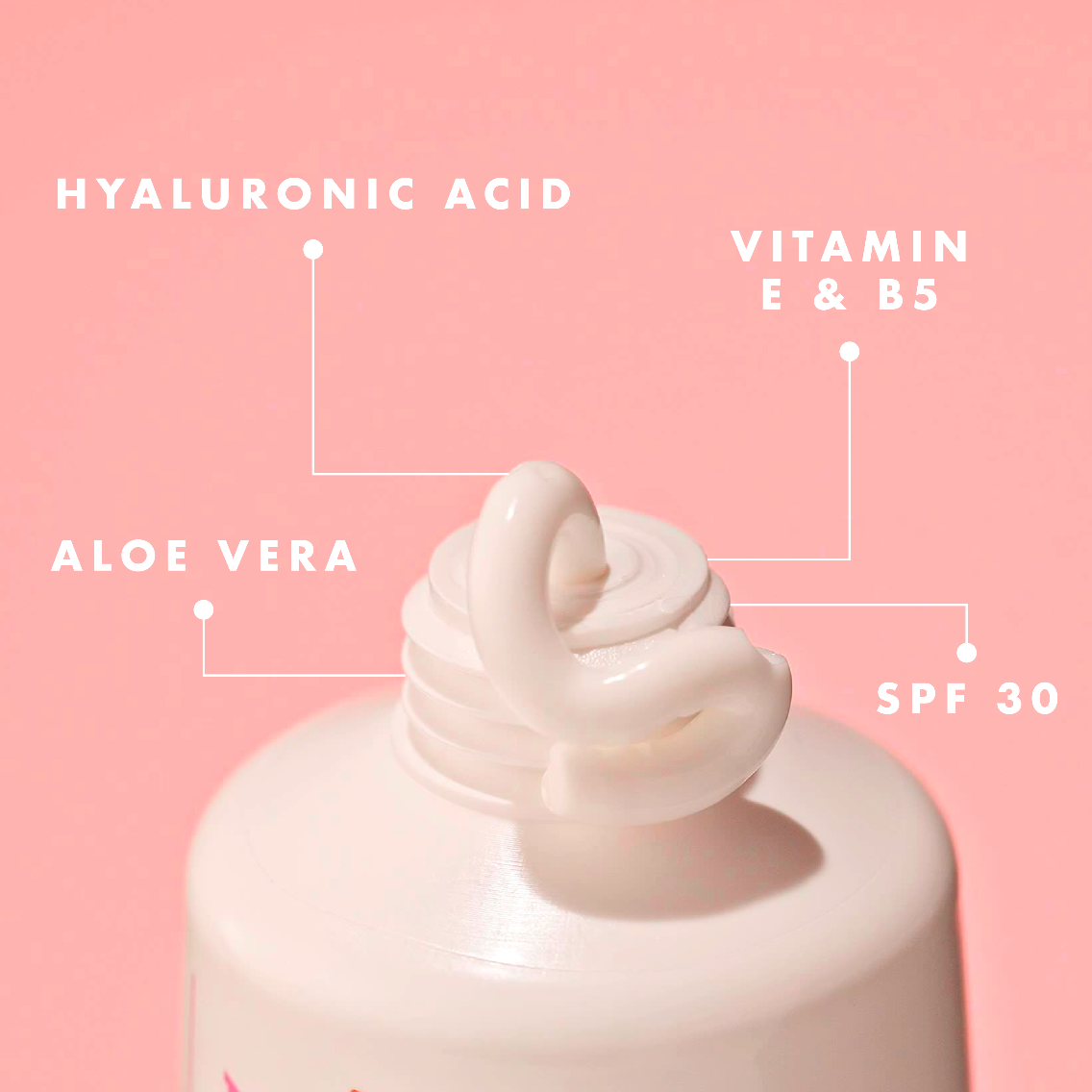 Lotion bottle with SPF 30 on a pink background, featuring hyaluronic acid, vitamin E & B5, and aloe vera.