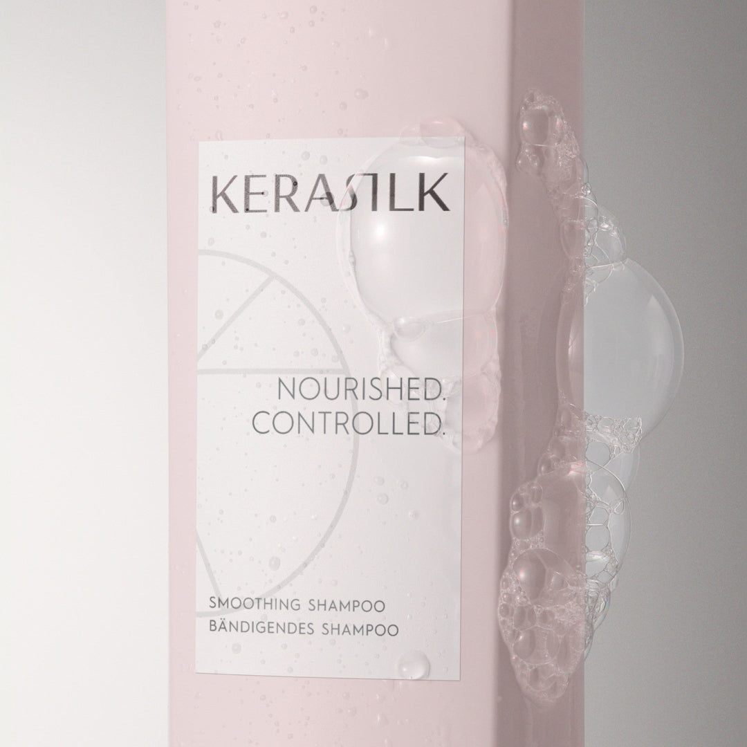 Kerastik shampoo bottle with a pink gradient and visible shampoo being applied.