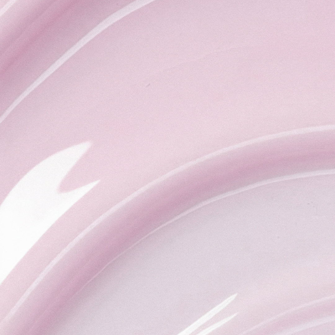Close-up of a pink and white ceramic plate with a subtle pattern.