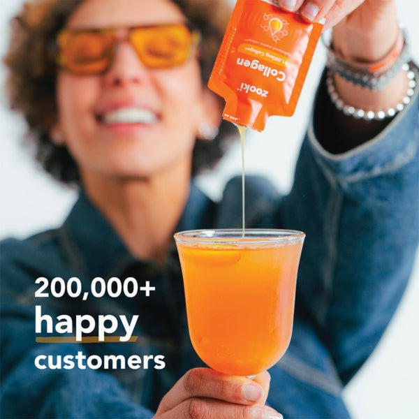 A person in a blue denim jacket and orange-tinted sunglasses pours orange collagen powder from a pouch into a glass of orange liquid. Text on the image reads '200,000+ happy customers'.