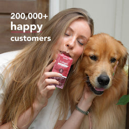 A woman and a golden retriever dog are shown together indoors, with the woman holding a pink pouch labeled 'Zoo' and 'Collagen'. Large white text in the upper left reads '200,000+ happy customers'.