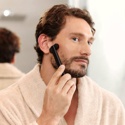 Man Using Red Light Face Wand