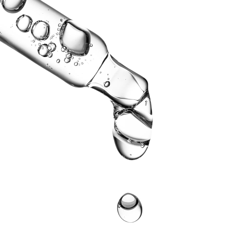 Close-up of a bottle cap with water droplets on a white background
