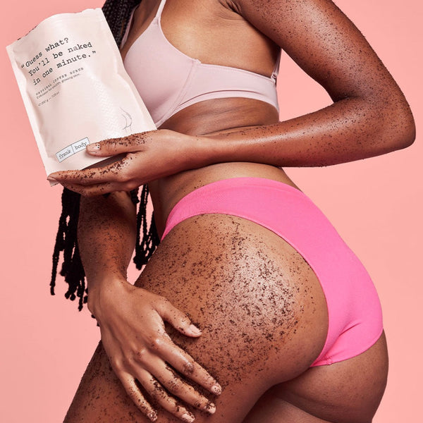 Person wearing pink underwear holding a product against a pink background