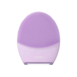 A lavender purple FOREO facial cleansing device with a textured silicone brush head, centered on a clean off-white background.