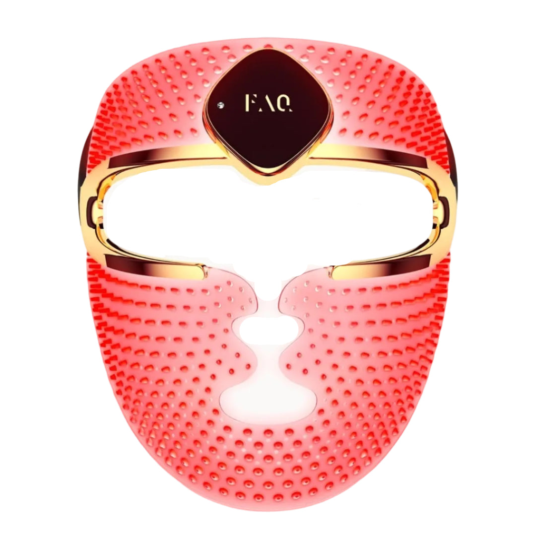 A red silicone facial massage mask with gold trim and a central dark brown plaque featuring the gold 'FAQ' logo, shown on a solid white background.