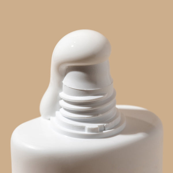 Close-up of a white bottle cap on a beige background