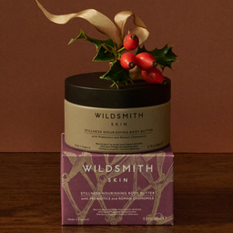 Wildsmith Skin body butter with holly leaves on a brown background