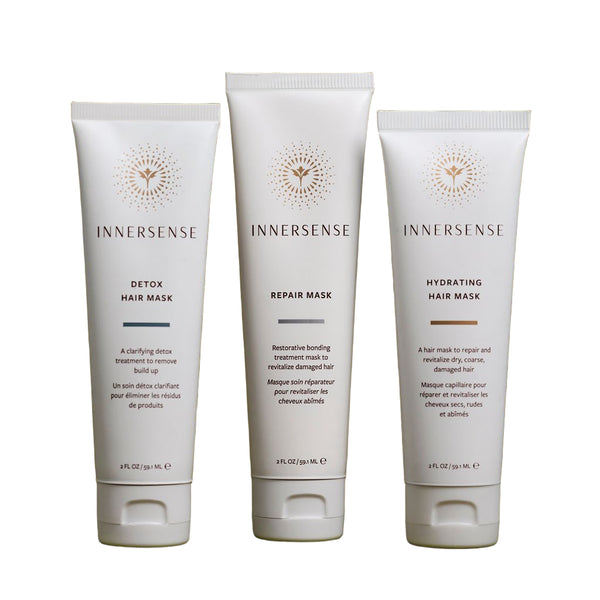 Three Innersense hair mask tubes on a green background