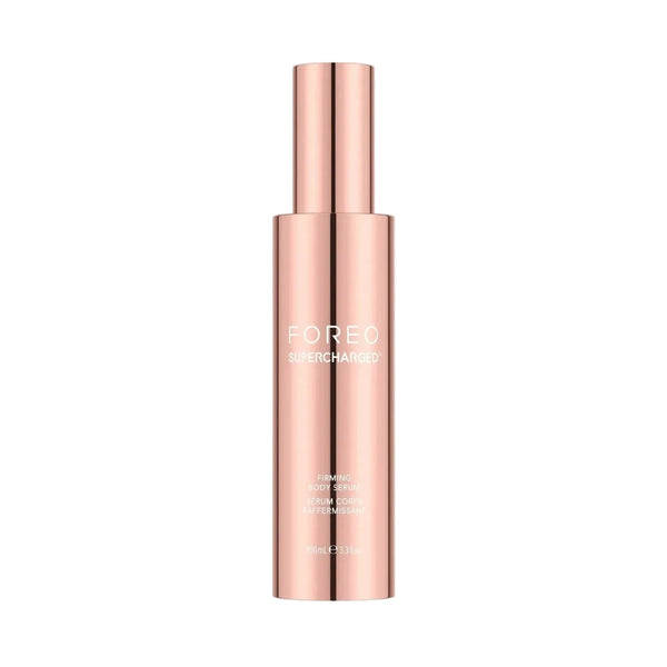 A sleek, metallic rose gold cosmetic bottle with a matching cylindrical cap, featuring the brand name 'FOREO' and product name 'EAR PIERCING' printed in white on the front, set against a solid off-white background.