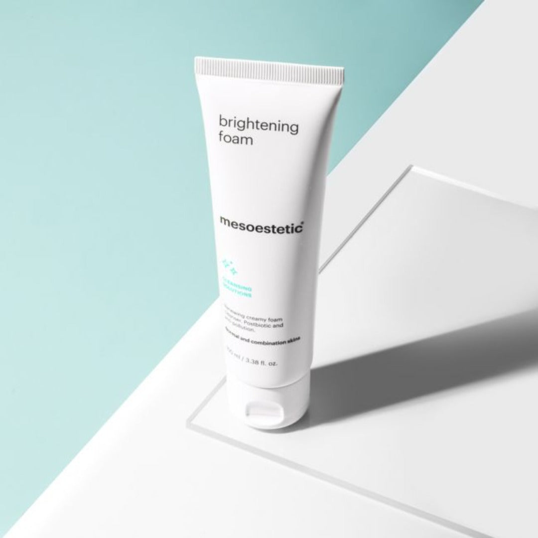 A tube of mesoestetic Facial Gel Cleanser (now Brightening Foam) on a glass slate with a green background